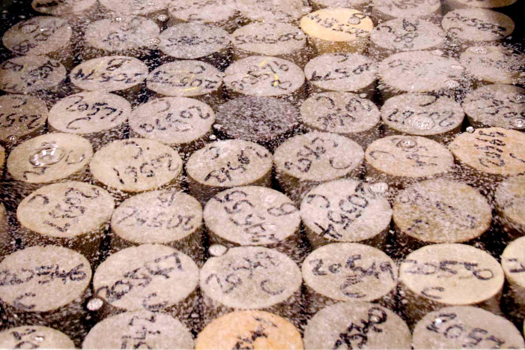 Concrete cylinders in a curing tank.